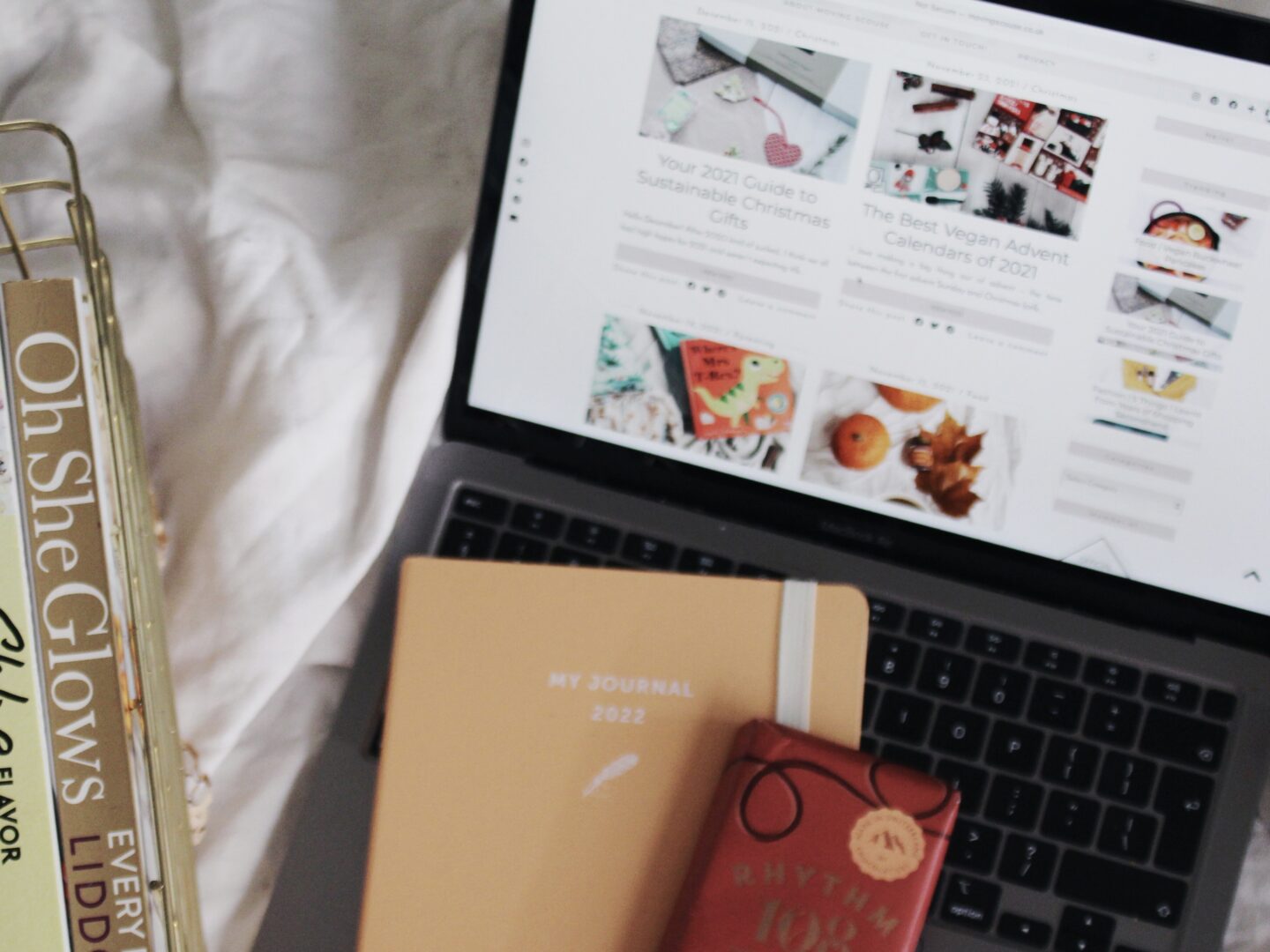 Decorative flatly with cookbooks, laptop, diary and chocolate, for a post about Veganuary.