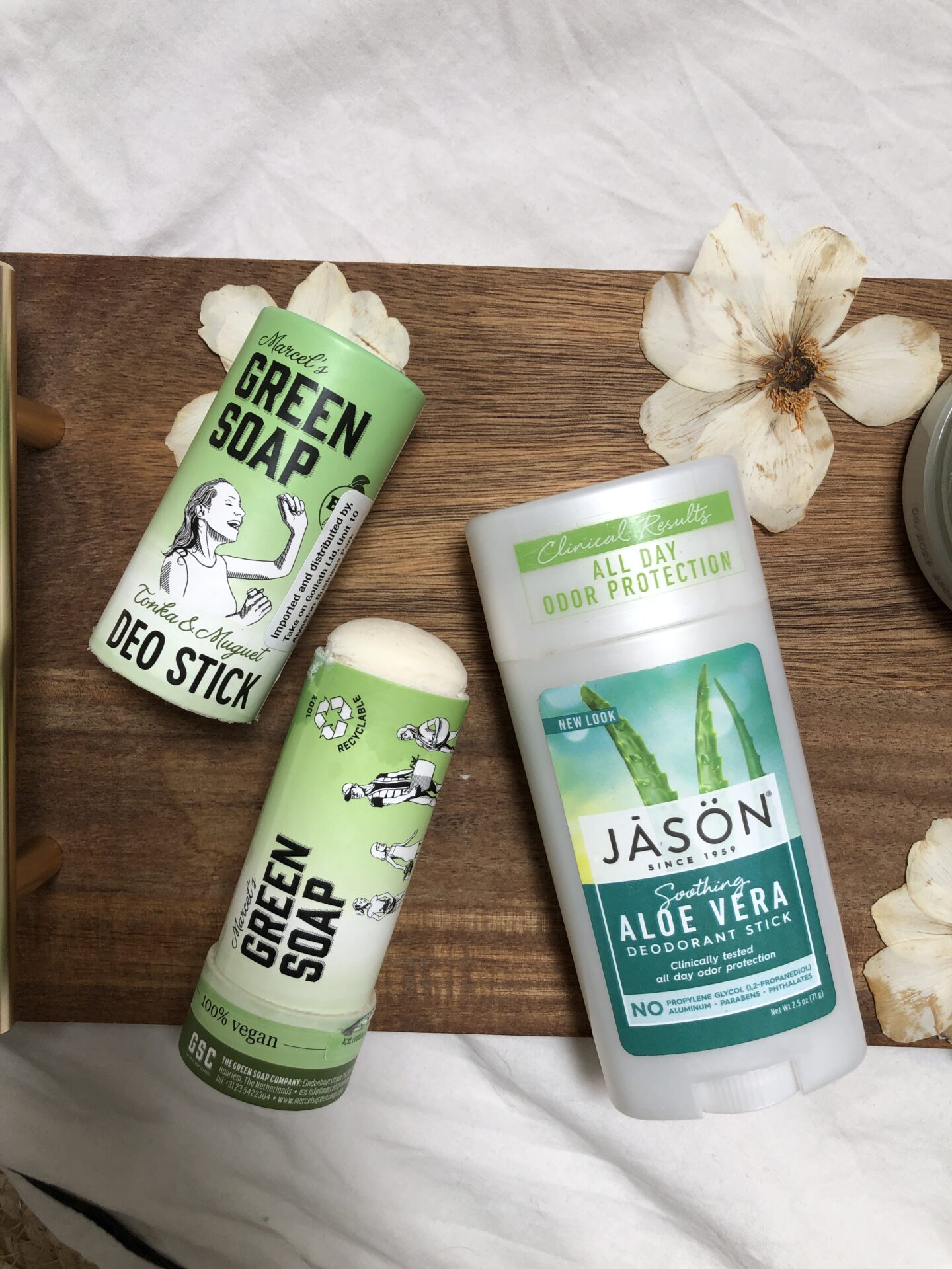 Flatlay of green vegan deodorants